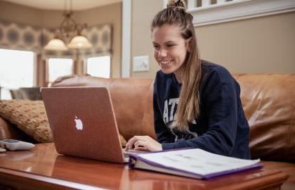 student working on laptop, online class